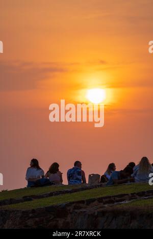 Galle, Sri Lanka - 02 15 2022: Group of tourists enjoying the picturesque view of the sunset at the Galle Dutch Fort. Stock Photo