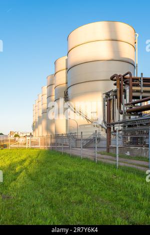 Huge oil tanks from the oil mill in the harbor of Hamburg. Storage tanks with soy oil in the industrial area of Hamburg. The company is one of the Stock Photo