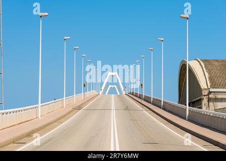 Bascule bridge across the shipping lane, where boats, ships, sailboats etc., reach the harbor Barcelona. The bridge leads to the cruise port. Stock Photo