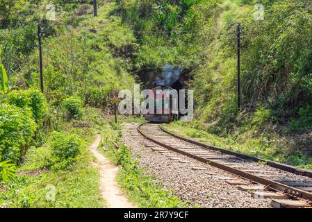 Shortly behind the nine arches bridge between Demodara and Ella, the track leads through a tunnel. The locomotive is on the way to Ella, in the Stock Photo