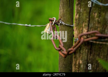 Padlock with a three digit combination on a fence Stock Photo