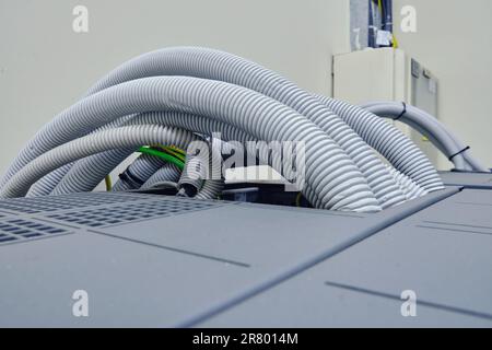 There are many wires running through the cable tray in the server room. Stock Photo