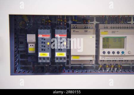 The industrial display shows the voltage of the electrical circuit. The automation technology includes a modern electrical control panel. Stock Photo