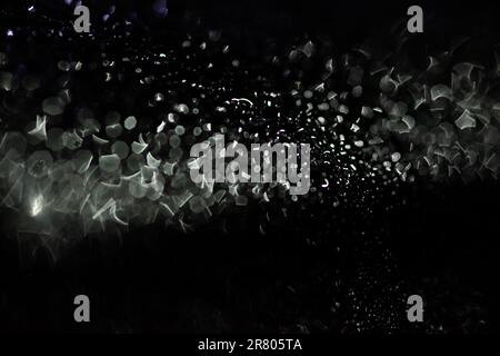 Abstract silver bokeh on black background Stock Photo