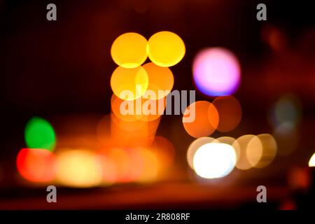 Blurred defocused lights at night. Abstract blur vehicle coming at night in the city. Stock Photo