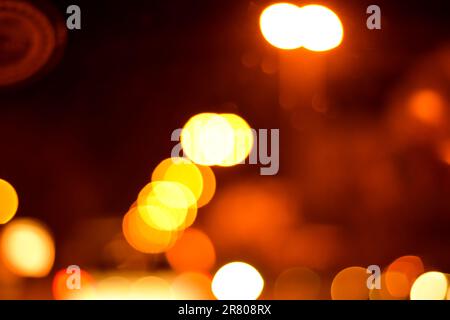 Blurred defocused lights at night. Abstract blur vehicle coming at night in the city. Stock Photo