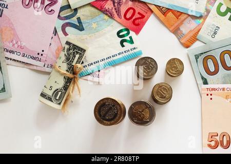 Turkish Banknotes and coins designed on white surface with Euro and American Dollar Banknotes.Monetary background,half view Stock Photo