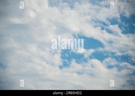 Scattered cloud clusters in a blue sky, blue sky background with white clouds. Stock Photo