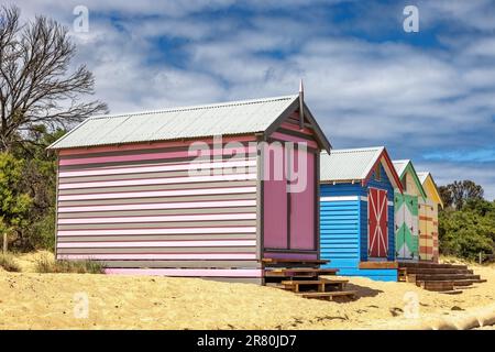 Brighton beach Victorain bathing boxes. Brightly painted colourful beach huts line the sand in Melbourne, Australia. They are highly desirable and ext Stock Photo