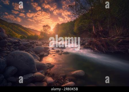 Magical sunrise over fast flowing mountain river with empty wooden ...