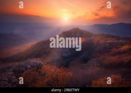Late autumn view of caucasus mountains in Georgia. Rays of light pass through the clouds Stock Photo