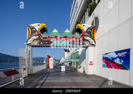 Indigenous artwork arch with two Bald eagles at entrance to Canada Place walkway in Vancouver, British Columbia, Canada on 2 June 2023 Stock Photo