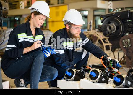 Engineer Reparing Machine Mechanical engineers repairing engine machine at factory Stock Photo ...