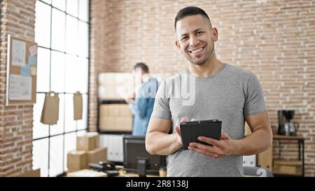 Two men ecommerce business workers using touchpad working at office Stock Photo