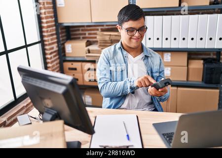 Down syndrome man ecommerce business worker using data phone at office Stock Photo