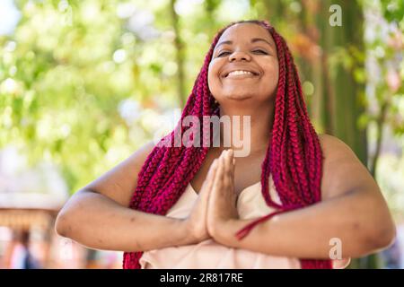 African american woman smiling confident doing yoga exercise at park Stock Photo