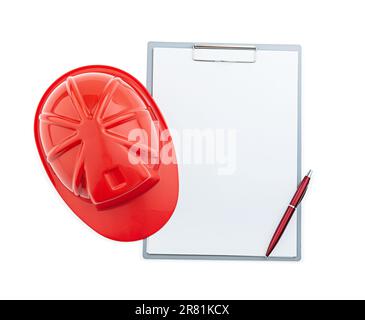 Red Construction Helmet And Ballpoint Pen On Clipboard Isolated Stock Photo