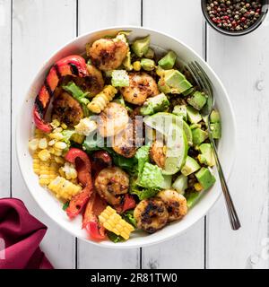 A healthy cajun prawn bowl with mixed vegetables, avocado and rice. Stock Photo