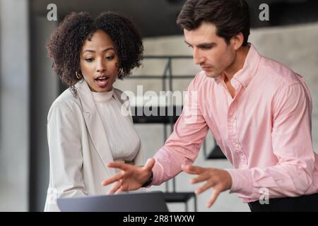 Enthusiastic multicultural employees working on project, office interior Stock Photo