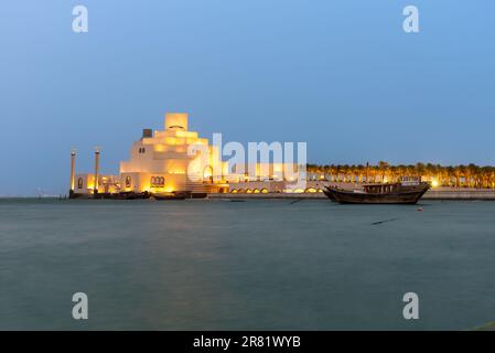 The museum of Islamic art  is built on an island off an artificial projecting peninsula near the traditional dhow (wooden Qatari boat) harbor. Stock Photo