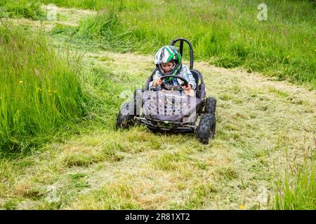 Electric powered Go-Kart racing around a field, High Bickington, North Devon, England, United Kingdom. Stock Photo