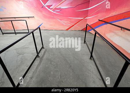 Handicapped down ramp with urban art on walls Stock Photo