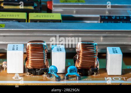 Closeup of power management supply board from samsung tv showing inductors and capacitors. Stock Photo