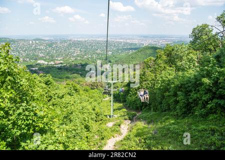 Budapest, Hungary – May 21, 2023. Zugliget Chairlift connecting Elizabeth Lookout tower to Zugligeti utca in Budapest, Hungary. View with people and v Stock Photo