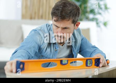man working and checking level with contour Stock Photo