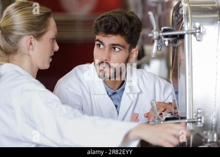 two brewery workers on beer production factory Stock Photo