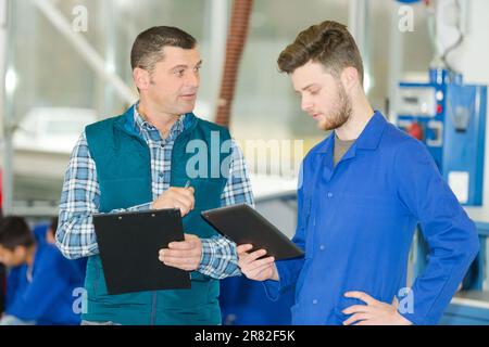 men working in a plant with tablet Stock Photo