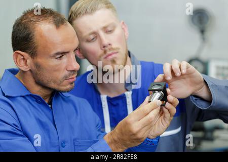 two men workers at a printer place Stock Photo