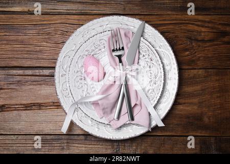 Festive table setting with painted egg and cutlery, top view. Easter celebration Stock Photo