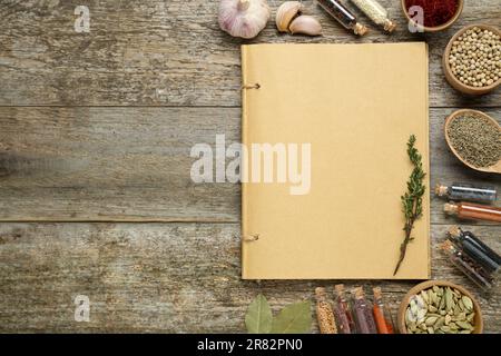 Blank recipe book and different ingredients on old wooden table, flat lay. Space for text Stock Photo