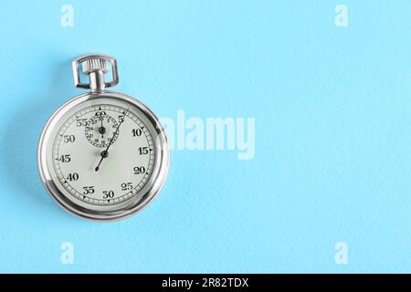 Vintage timer on light blue background, top view with space for text. Measuring tool Stock Photo