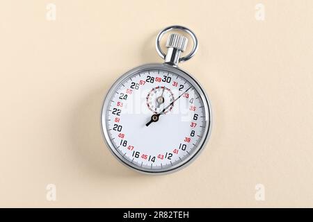 Vintage timer on beige background, top view. Measuring tool Stock Photo