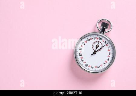 Vintage timer on pink background, top view with space for text. Measuring tool Stock Photo