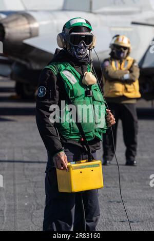 Aviation Boatswain's Mate (Equipment) 3rd Class Darion Thornton (left), from Charleston, South Carolina, assigned to the world’s largest aircraft carrier USS Gerald R. Ford’s (CVN 78) air department, operates the jet blast deflectors on the flight deck, June 9, 2023. Gerald R. Ford is the U.S. Navy’s newest and most advanced aircraft carrier, representing a generational leap in the U.S. Navy’s capacity to project power on a global scale. The Gerald R. Ford Carrier Strike Group is on a scheduled deployment in the U.S. Naval Forces Europe area of operations, employed by U.S. Sixth Fleet to defen Stock Photo