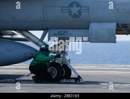 Aviation Boatswain's Mate (Equipment) 2nd Class Sarah Roberts, from Cartersville, Georgia, prepares an F/A-18F Super Hornet, attached to the 'Blacklions' of Strike Fighter Squadron (VFA) 213, for launch on the flight deck of the worldÕs largest aircraft carrier USS Gerald R. Ford (CVN 78), June 16, 2023. VFA 213 is deployed aboard CVN 78 as part of Carrier Air Wing (CVW) 8. Gerald R. Ford is the U.S. NavyÕs newest and most advanced aircraft carrier, representing a generational leap in the U.S. NavyÕs capacity to project power on a global scale. The Gerald R. Ford Carrier Strike Group is on a s Stock Photo
