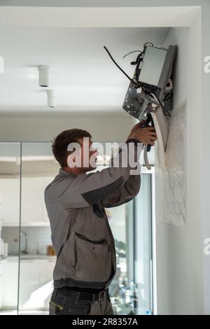 Man technician repairing apartment air conditioner Stock Photo