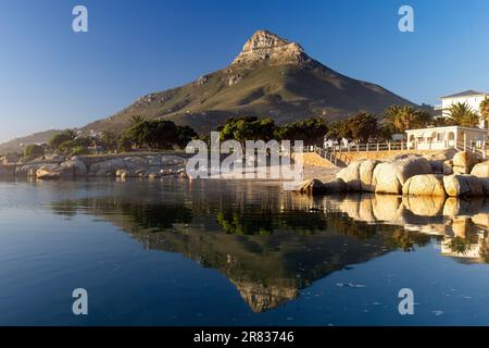 Reflections of Lion's Head mountain in Camps Bay Tidal Pool at sunset - Camps Bay - Cape Town, South Africa Stock Photo