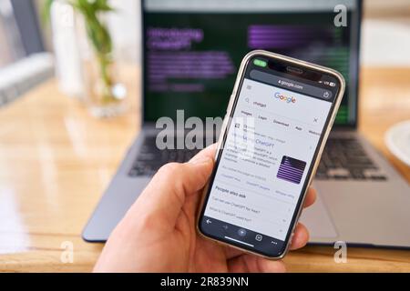 Spain, Barcelona - March 20 2023: Request to Google chat GPT. ChatGPT chat bot screen seen on smartphone and laptop display with Chat GPT login screen Stock Photo