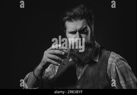 Bartender leather apron holding whisky cocktail in glass. Old traditional whiskey drink - gentlemen beverage. Stock Photo