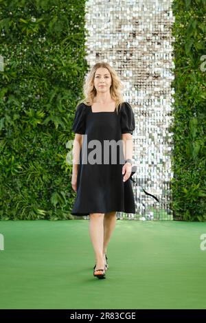 A stylish middle-aged woman in a black linen sundress with blonde curly hair Stock Photo