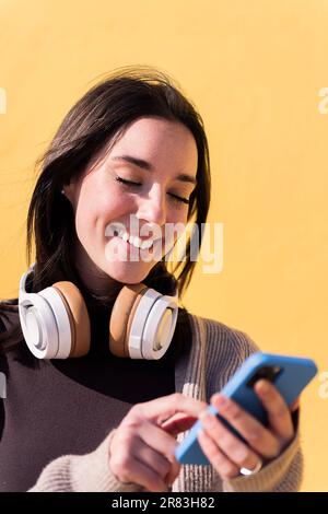 happy young woman using smart phone Stock Photo