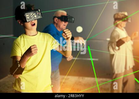 Boy playing VR games with his family Stock Photo