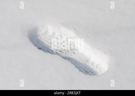 Footprint of a boot in the snow Stock Photo