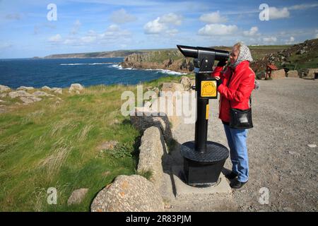 Tourist looking through telescope, Lands End, Cornwall, England, United Kingdom Stock Photo