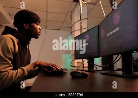 Hacker cyberattack, data breach, man coding password hacking software, breaking into computer internet server. Cybercrime, database information stealing, internet security technology concept Stock Photo