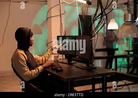 Cyber security, developer coding antivirus program, data encryption. African american it specialist programming app, cybersecurity technology, malware development, computer system protection Stock Photo